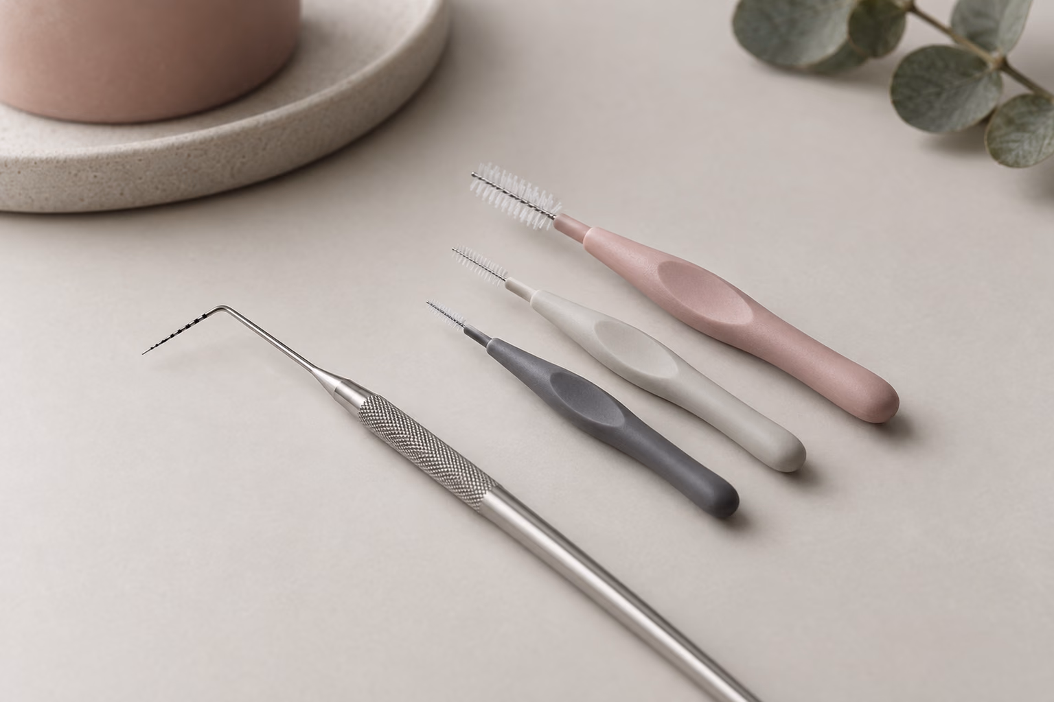 Illustrative image: a millimetre periodontal probe and interdental brushes